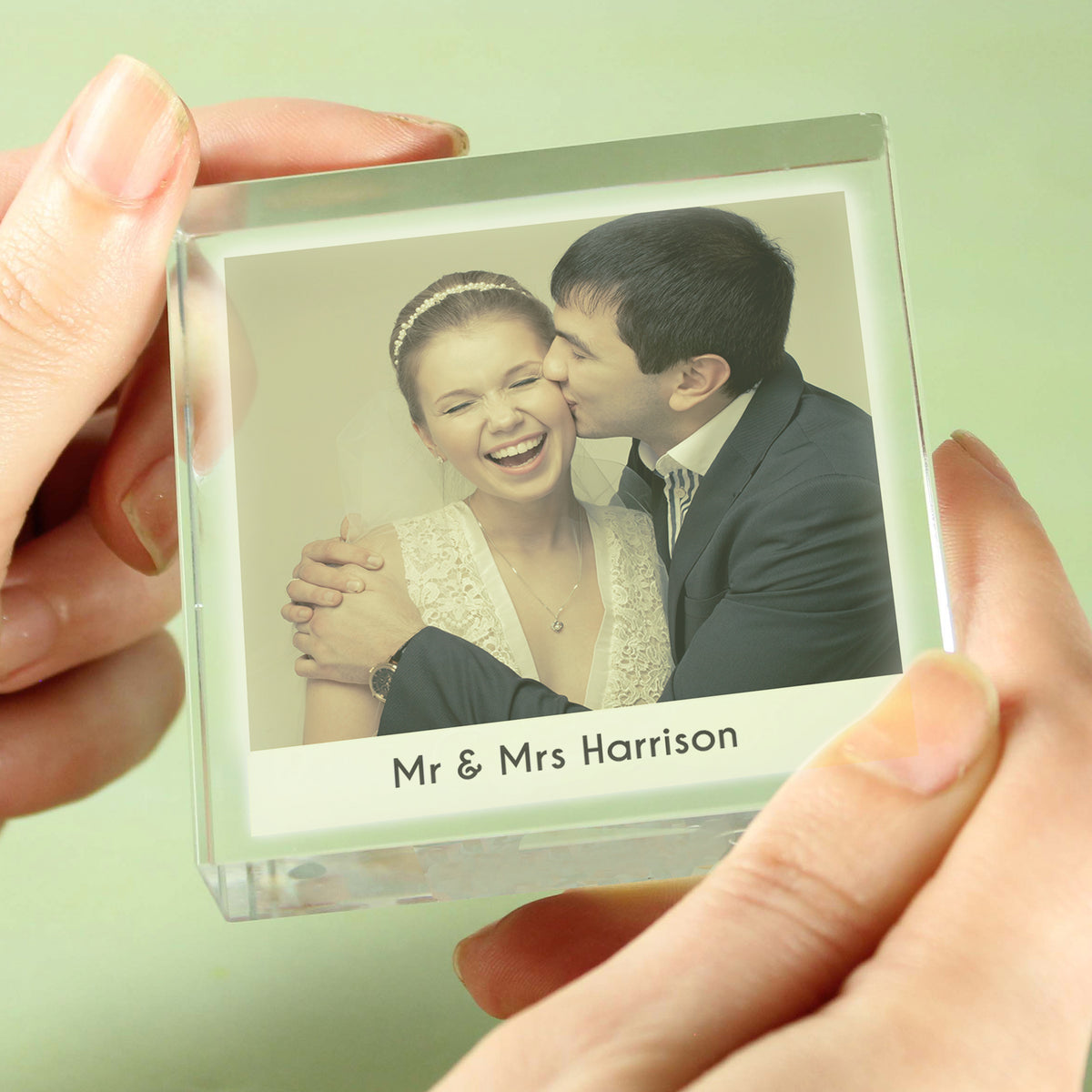 Hand holding a personalised crystal photo token