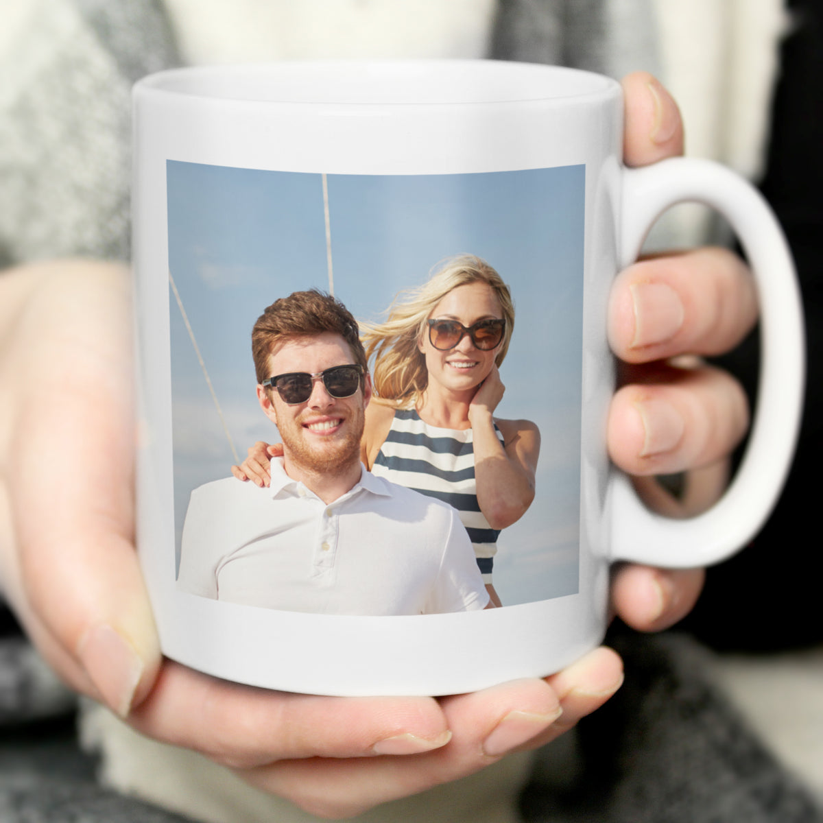 Close-up of a personalised photo upload mug held in hand