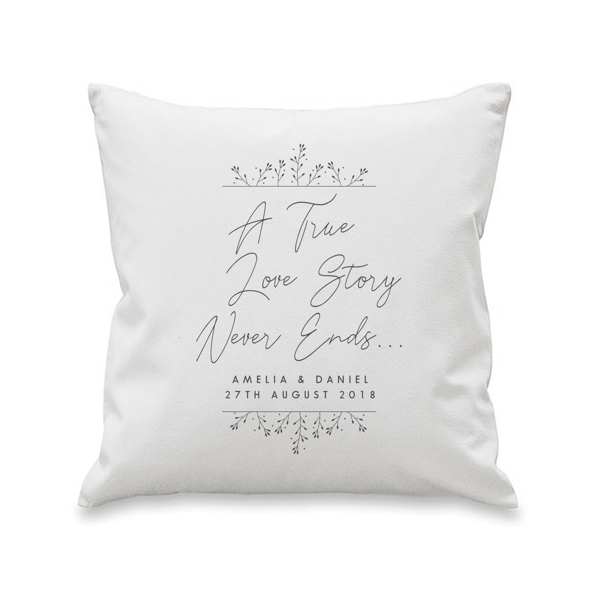 White cushion personalised with couples names and date beneath A True Love Story Never Ends