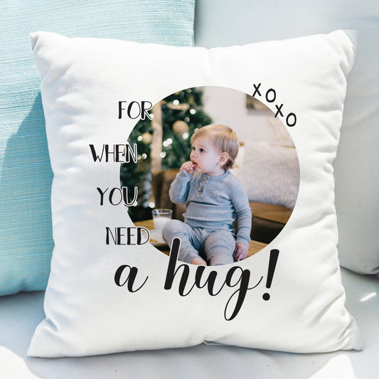 Personalised photo cushion with Need a Hug design on a sofa