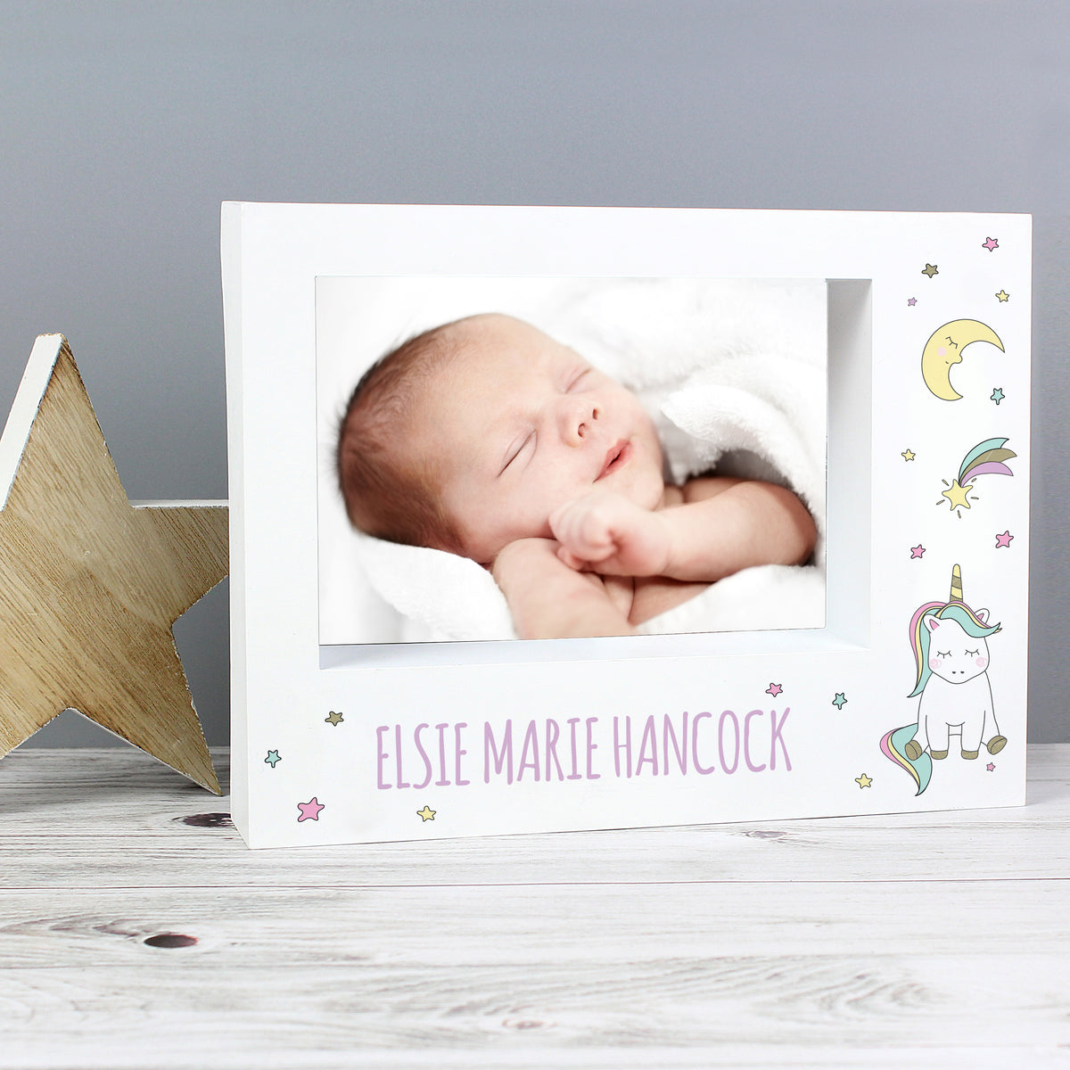 Baby Unicorn landscape frame beside a wooden star with a sleeping baby photograph
