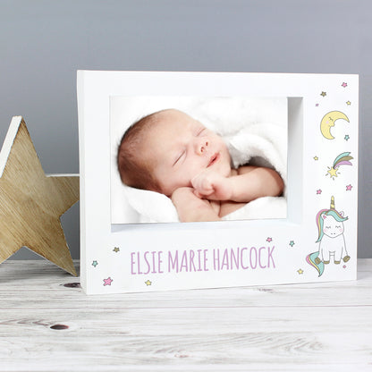 Baby Unicorn landscape frame beside a wooden star with a sleeping baby photograph