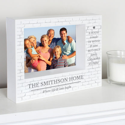 White Family frame on a shelf with the Smithson Home example wording and a family photograph