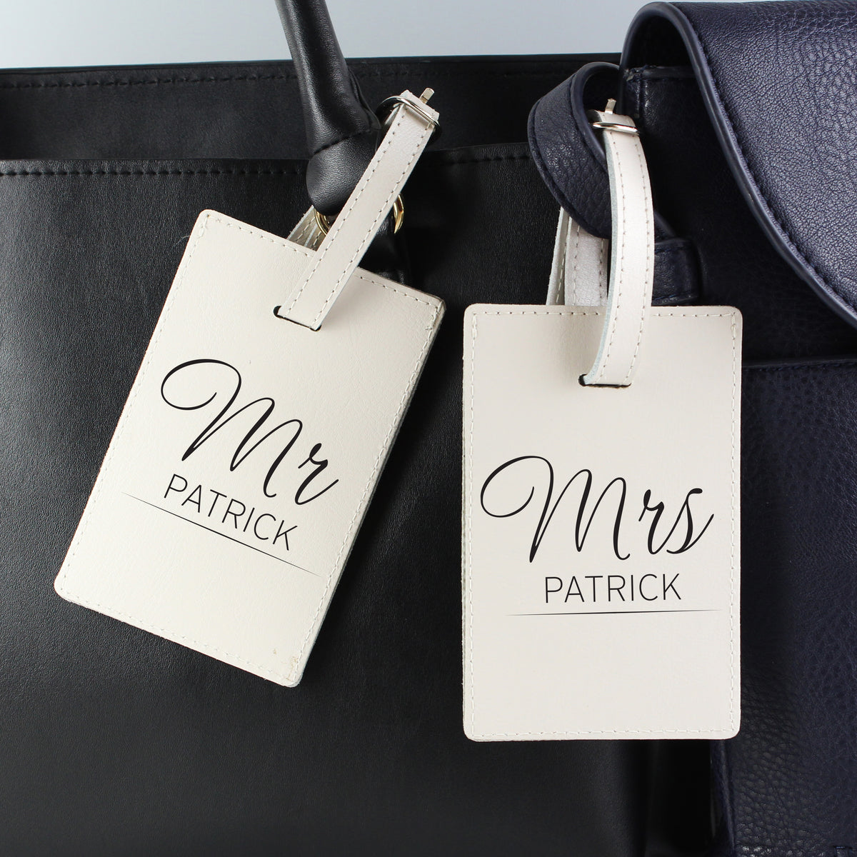 Pair of classic cream leather luggage tags personalised for a couple